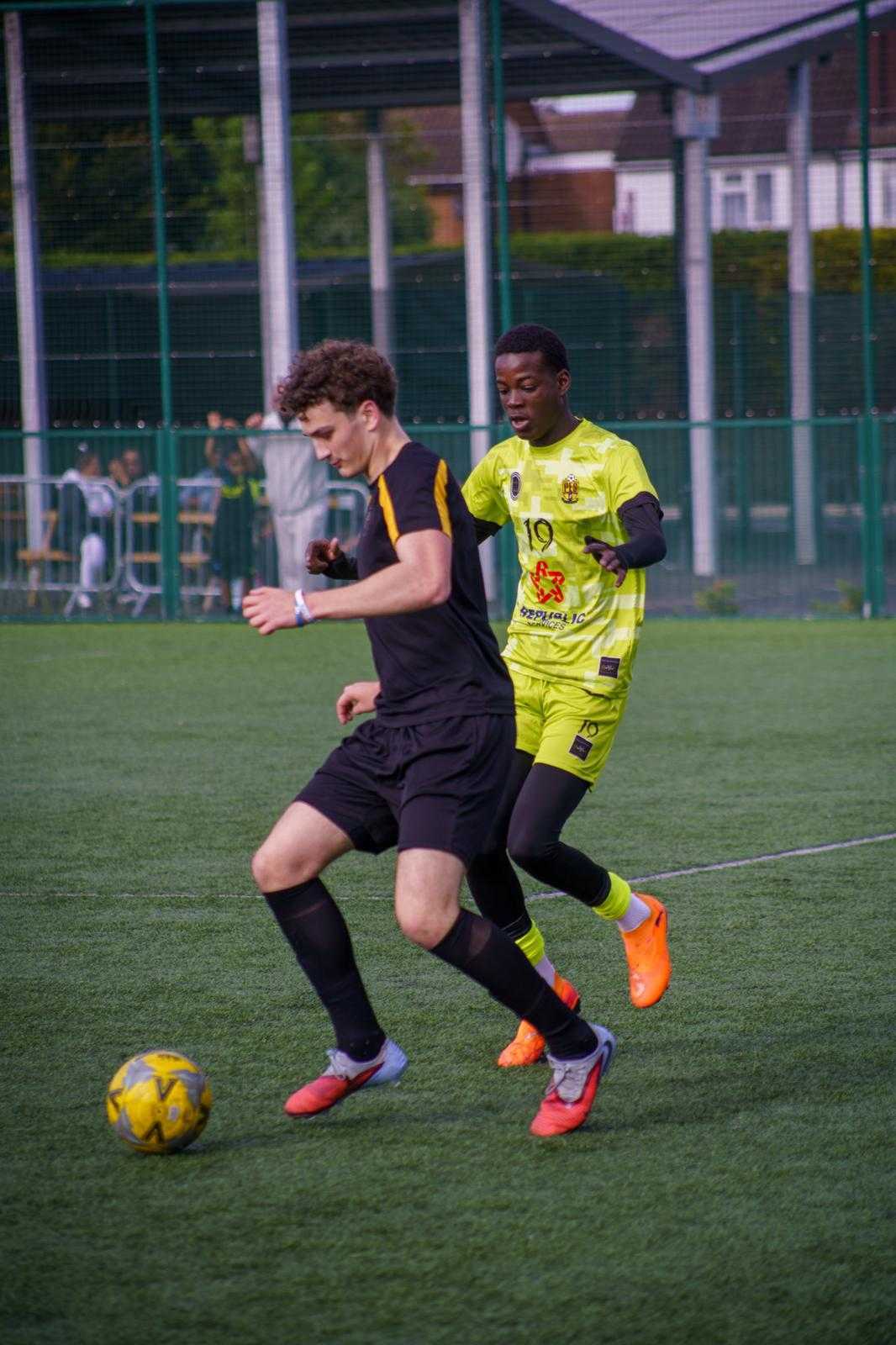 Two players duelling for the ball in a match