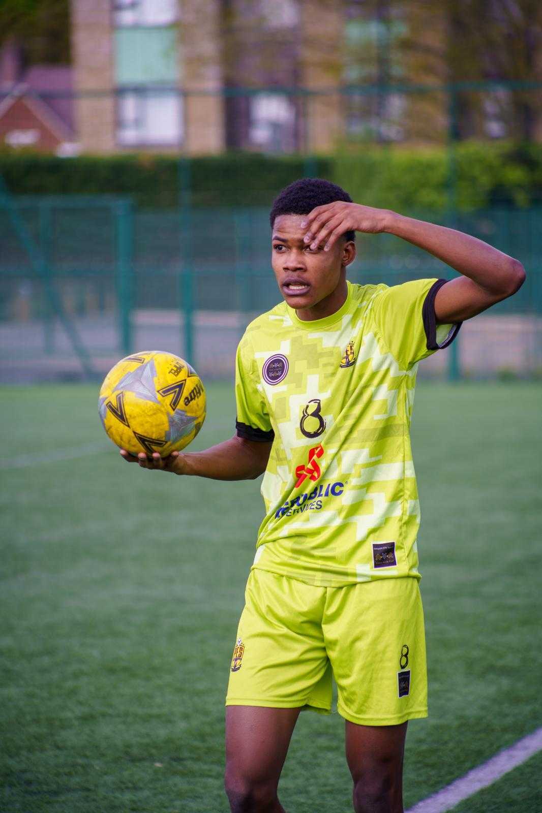 Player holding the ball and calling a throw-in