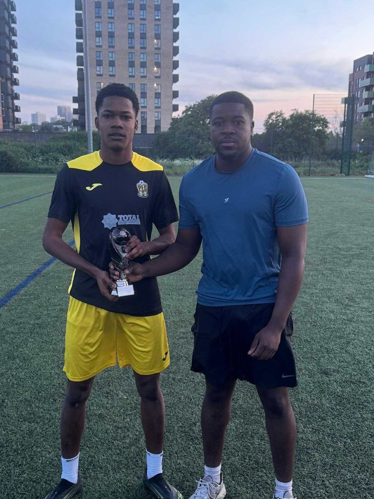 Player receiving a trophy after the final whistle